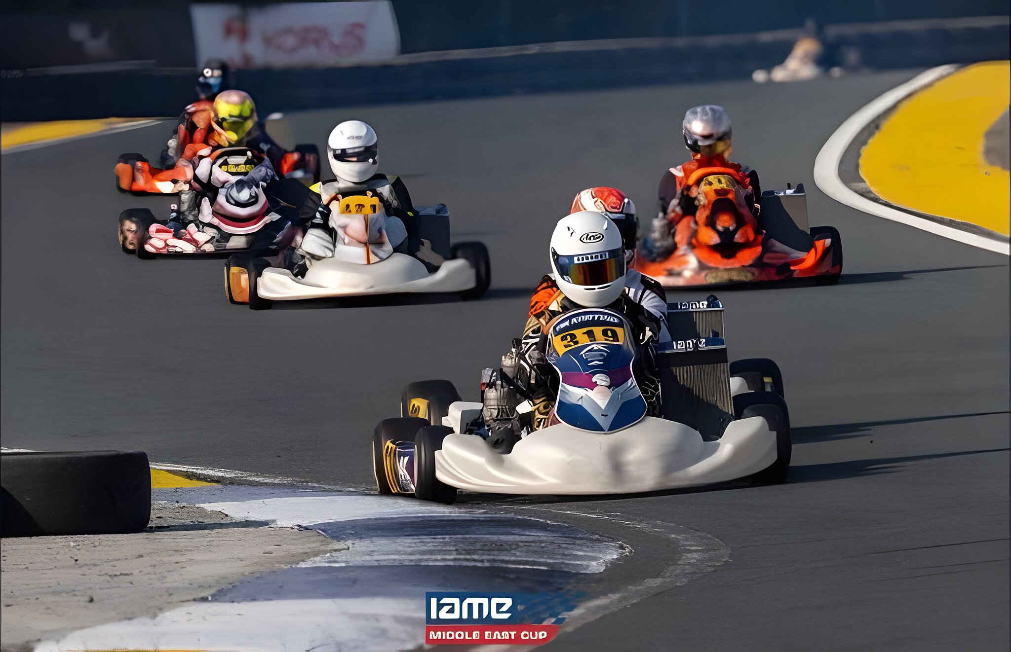 Two karts side by side into the corner, nobody lifting
