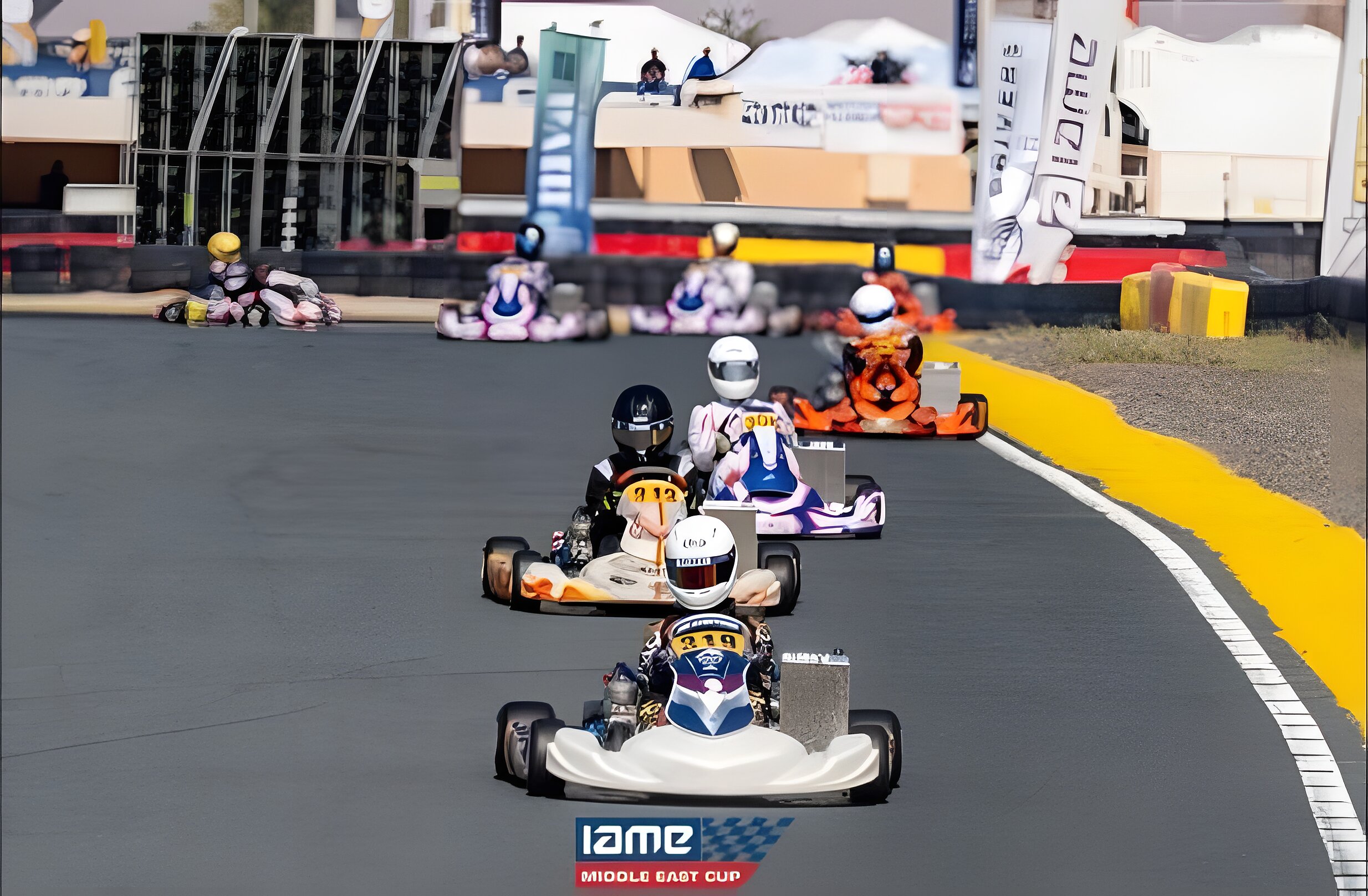 Race start at RAK Track, the whole grid funnelling into turn one through tyre smoke