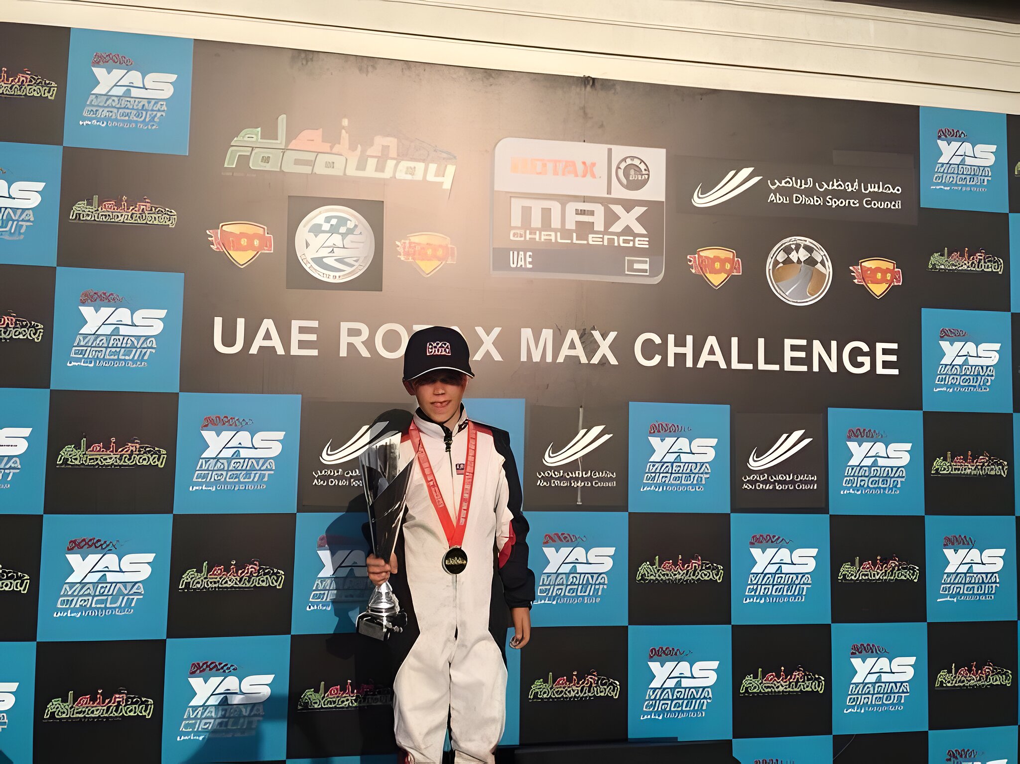 On the podium at the UAE Rotax Max Challenge, medal on
