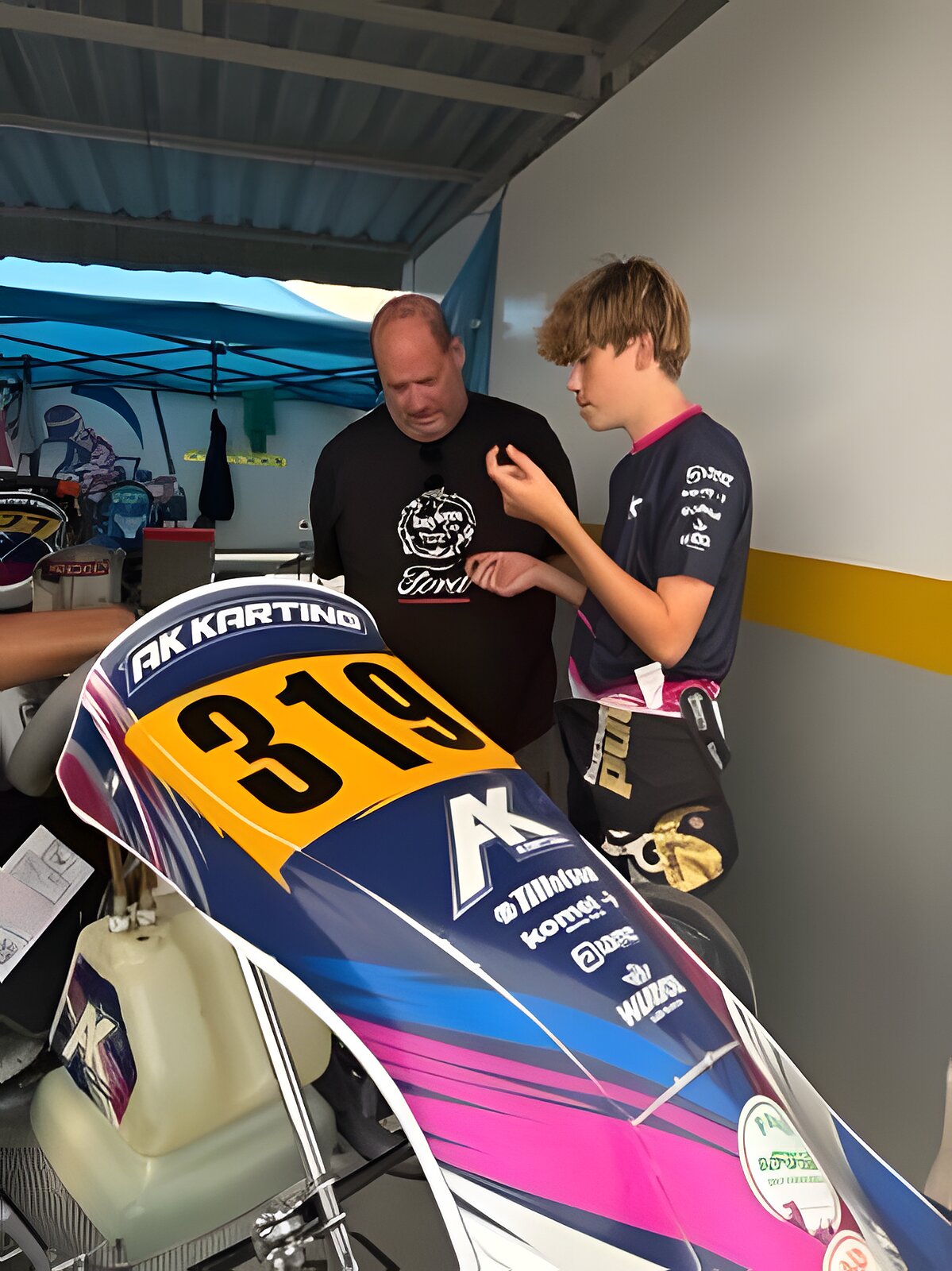 Zac, leaning over the number 319 bodywork, talking through the session with his engineer
