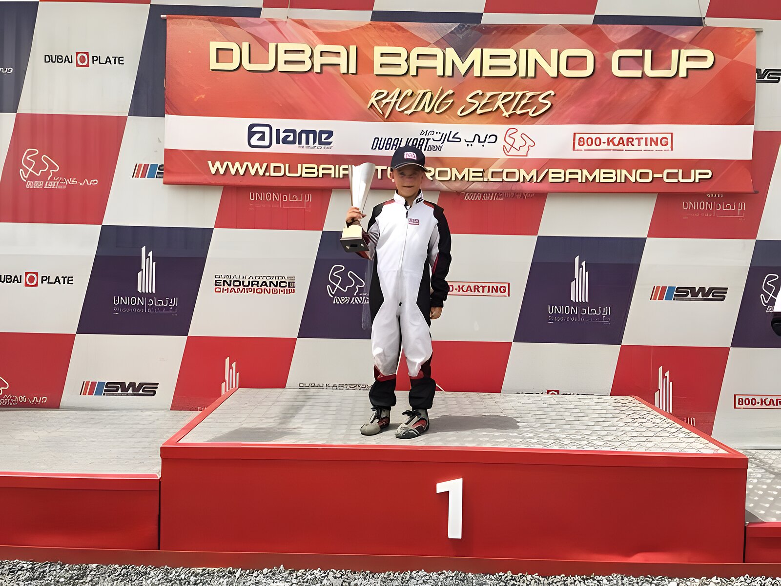 Top step of the Dubai Bambino Cup podium, trophy in hand