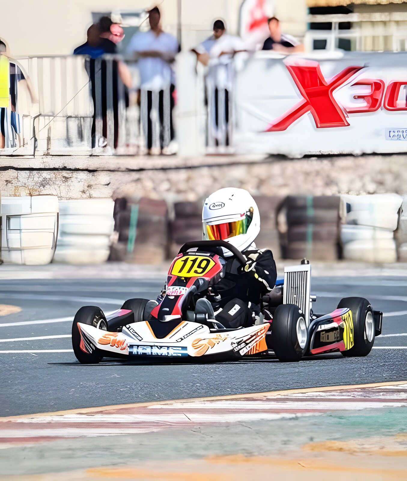 Kart 119 on the kerbs at Dubai Kartdrome, X30 board behind