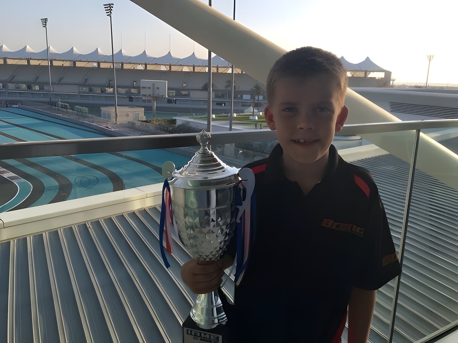 Six years old at Yas Marina, trophy already in hand, the Formula 1 circuit behind